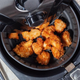 Air fryer full of crispy chicken